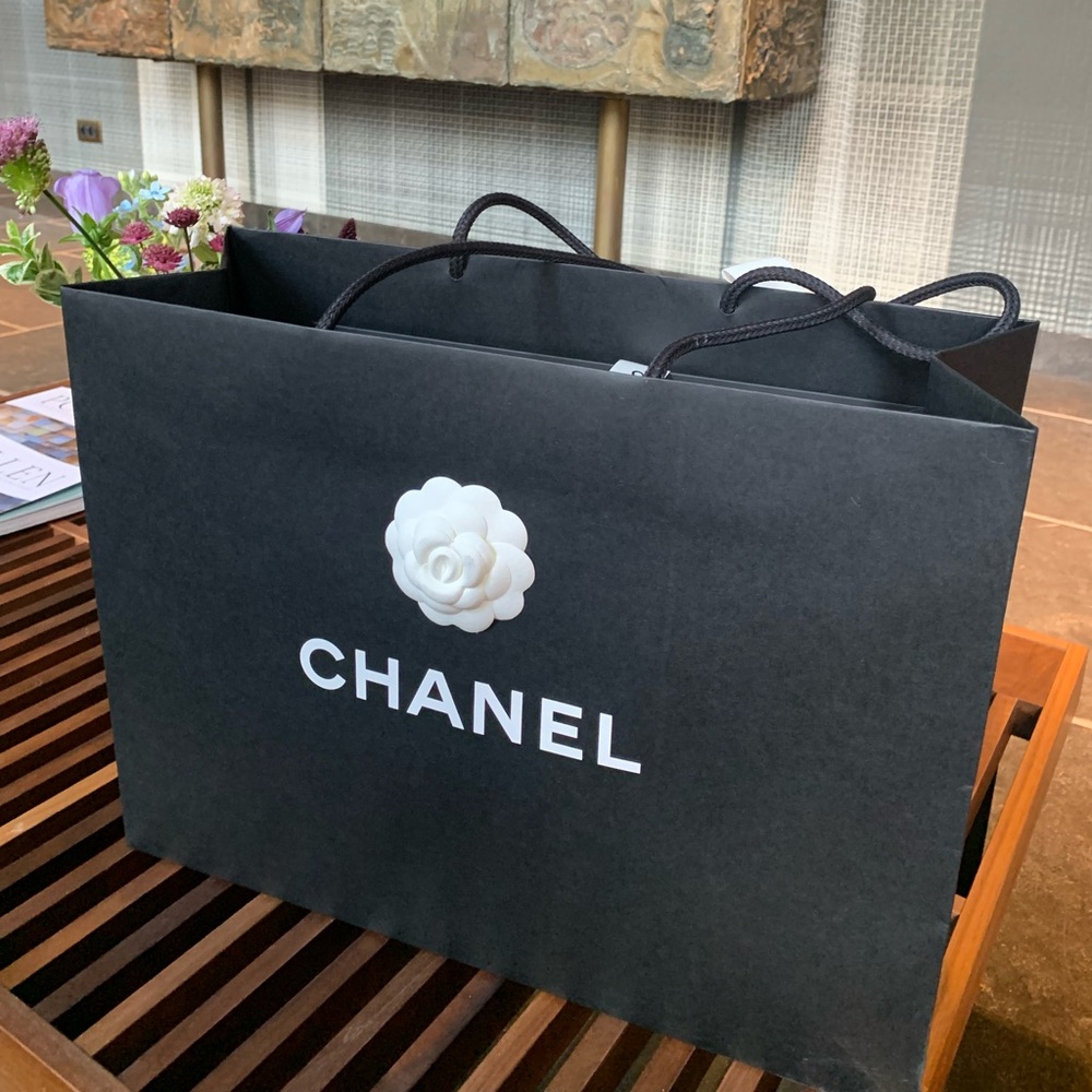 Brand new one authentic Large Chanel black paper bag with ribbon and camellia